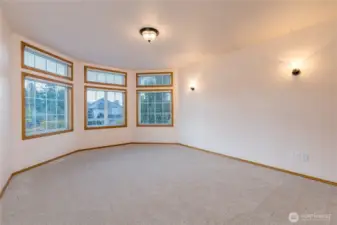 Another bedroom view, featuring bay windows
