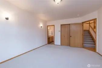 One of the two primary bedroom suites, with new carpet and light fixtures, and dual french doors