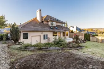 The back yard of the property; notice the numerous roof skylights as well.