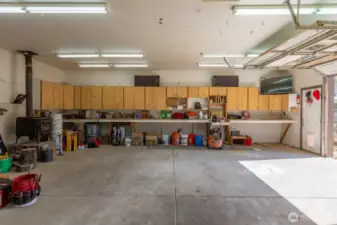 Tons of storage cabinet space in the garage, PLUS a wood stove.
