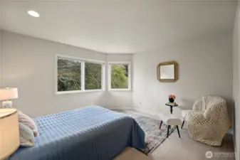 Primary bedroom with a view to the trees