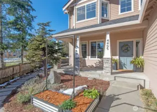 Front porch and raised garden beds greet you as you come home.