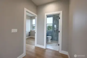 Hallway to guest bath and utility room