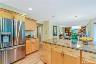 The kitchen seamlessly connects to the family room, offering an open-concept layout perfect for gatherings. A cozy brick fireplace and built-in shelves add charm and warmth to this inviting living space.