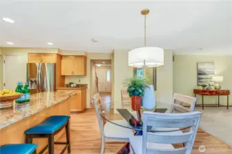 Overlooking the backyard, this inviting dining space is bathed in natural light. A stylish light fixture enhances the room’s ambiance, making it an ideal setting for everyday meals and special gatherings.