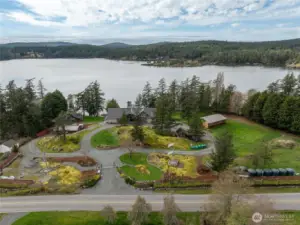 Pass through the gated entry into 4 park-like acres of this magical, waterfront compound.