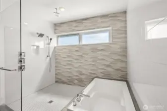 Spacious walk-in shower and soaking tub with lavish detailing.