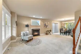 Greeted by a large living space and dining room.