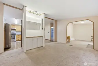 Living room looking toward kitchen and den/office