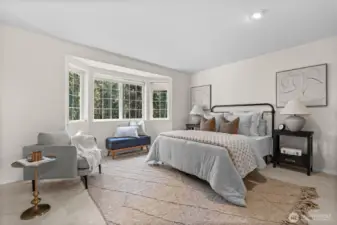 Expansive primary bedroom, with a beautiful window nook to enjoy cozy mornings.
