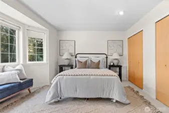 Comfortable primary bedroom showcased with natural lighting.