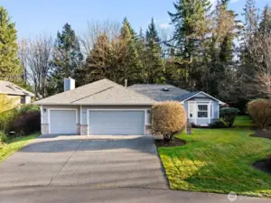 Wonderful concrete driveway allows graceful entry to this mid-century modern rambler.
