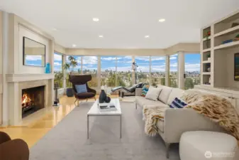 Just inside the formal entry is this beautiful living room replete with built-ins, and expansive floor-to-ceiling windows looking out to the stunning view.