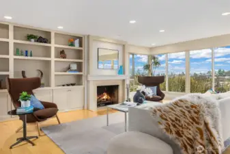 There's even more space for displaying books and art object--with cupboards below--in the additional built-ins to the left of the fireplace.  Additional soft light enters this space through a window looking out upon the entry courtyard (to the left, out of frame in this photo.)