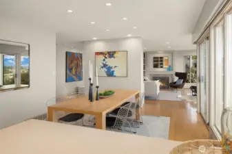 The dividing wall that delivers built-ins on the living room side, offers an opportunity to display art on the dining side.  The formal entry is to the left.