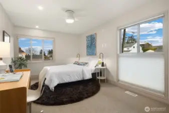 One of two additional spacious bedrooms upstairs.