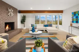 The daylight lower level features this huge family room with wood-burning fireplace and windows looking out toward the backyard and views.  There is gas plumbed to the fireplace for easy conversion.