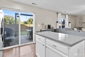 Island counter with additional drawers / cabinetry. Step out the slider onto deck in fully fenced back yard.