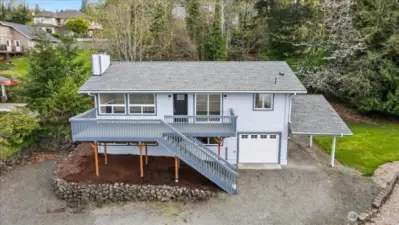 Sitting Stately with a new roof, deck, siding, paint, and garage door. All that's missing is YOU!