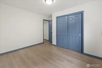 Standing near the window in the 3rd bedroom.