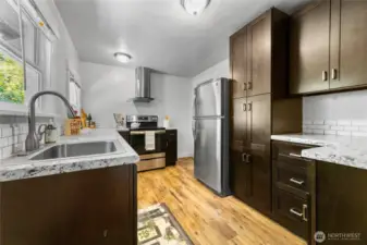 Stunning, updated kitchen with stainless appliances, lots of cabinetry and storage