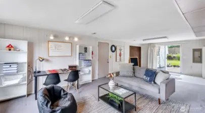 Enjoy seamless access to the outdoors through sliding doors that open to a spacious area—more than just another living room, it’s a versatile space perfect for relaxing and entertaining