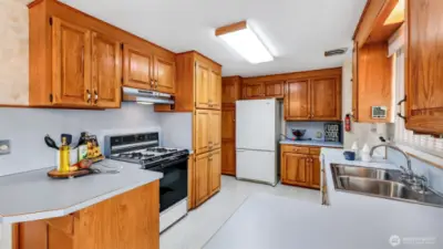 With abundant classic cabinetry and generous counter space, this kitchen is thoughtfully designed for those who love to cook and keep everything in order