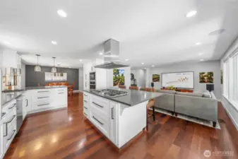 Gleaming Olive wood floors, custom white cabinets, quartz counters......