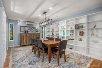 The generous dining room offers ample space for gatherings and features custom built-in shelving—perfect for displaying serveware, books, or curated collections.