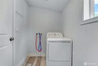 Laundry room with space for storage.