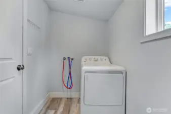 Laundry room with space for storage.