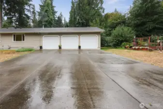 Large driveway to 3 car garage located on the side of the home