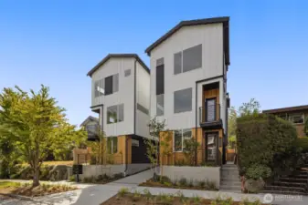 A closer look at the exterior reveals bold rooflines, oversized windows, and a carefully curated façade that speaks to both craftsmanship and style.