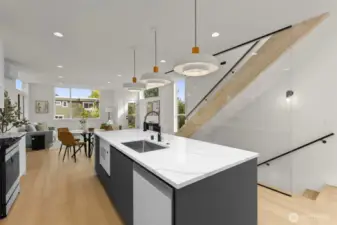 The oversized island invites connection, serving as a gathering point for guests, a prep space for meals, or a quiet spot for morning coffee.