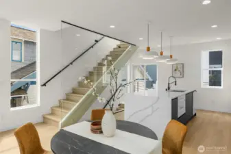 Modern railings and wood accents highlight the craftsmanship of the staircase while adding warmth to the home’s contemporary aesthetic.