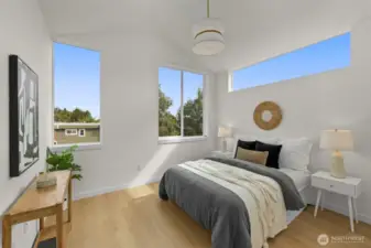The primary suite offers a serene retreat with treetop views, oversized windows, and room to curate your ideal restful haven.