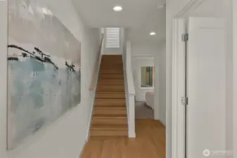 The inviting entry hall leads to a versatile main-floor bedroom suite—perfect for guests or a quiet home office.