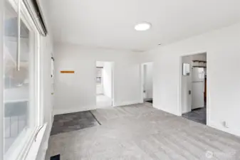 First bedroom on the left, hallway to bath and second bedroom in the center, kitchen to the right and basement stairwell to the right.