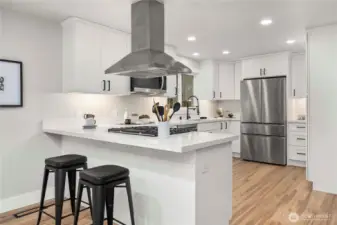 Brand new kitchen and appliances with eat in bar seating.