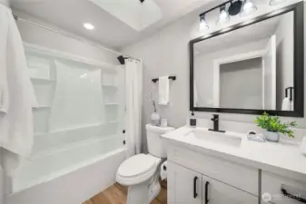 Upstairs gust bathroom with skylight.