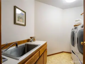 The spacious laundry room is located next to the garage entrance.