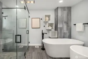 Spa bathroom for the primary suite: tiled floor, soaking tub, shower, separate toilet and dual sinks.