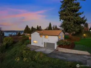 Side garage access, workshop (the lit window), and great driveway parking.