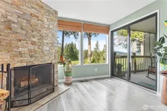Large picture window, cozy woodburning fireplace, and brand new sliding glass door.