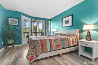 Primary bedroom with separate door to balcony.