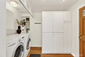 The laundry room is adjacent to the kitchen and has plenty of storage