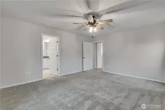 Primary suite angle showcasing the entrance to the private ensuite.