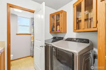 Laundry with built in cabinetry.