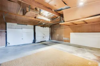 Two car garage with door to back patio