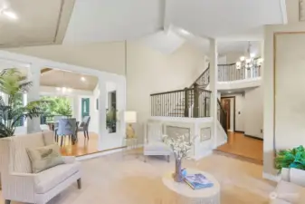 This formal living room highlights the gorgeous angles in the architecture and open staircase.